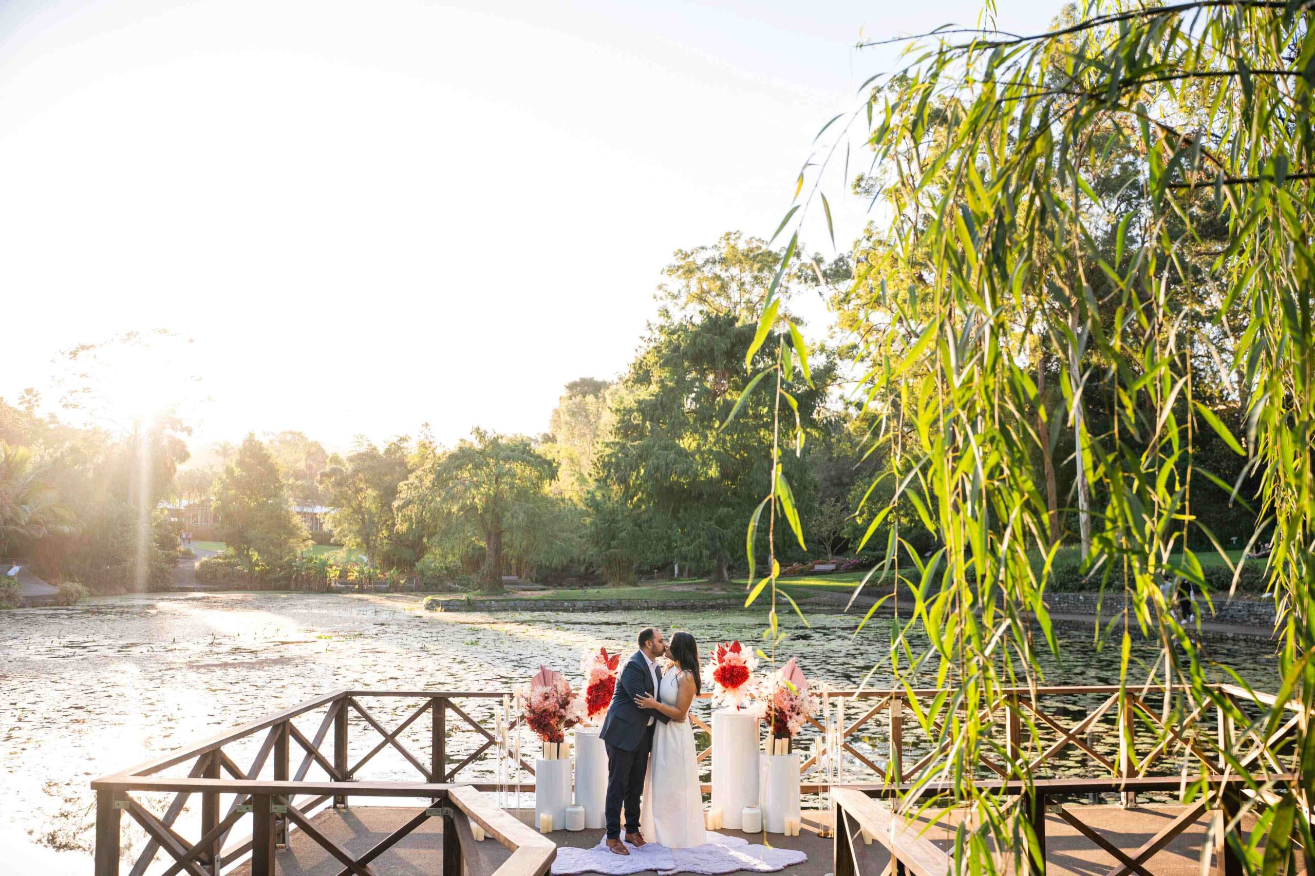 couple celebrating their engagement with a kiss